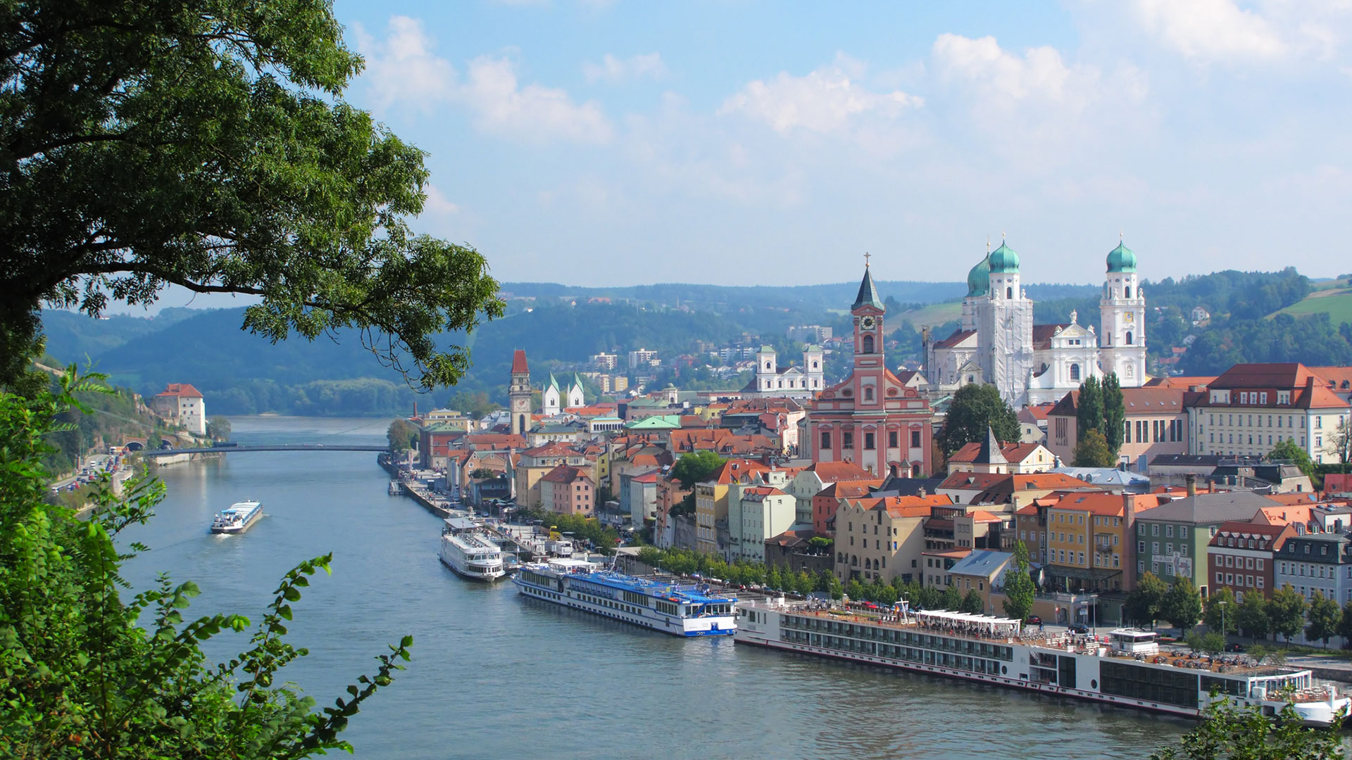 Passau’s old town and cathedral with river cruise ships moored along the bank